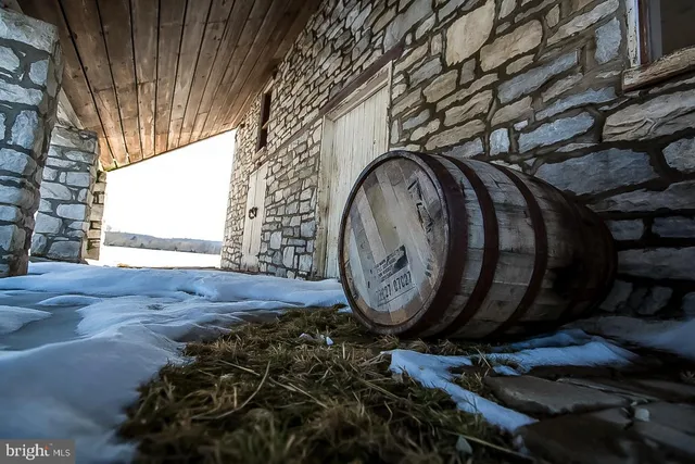 a view of a workspace with furniture and a bookshelf