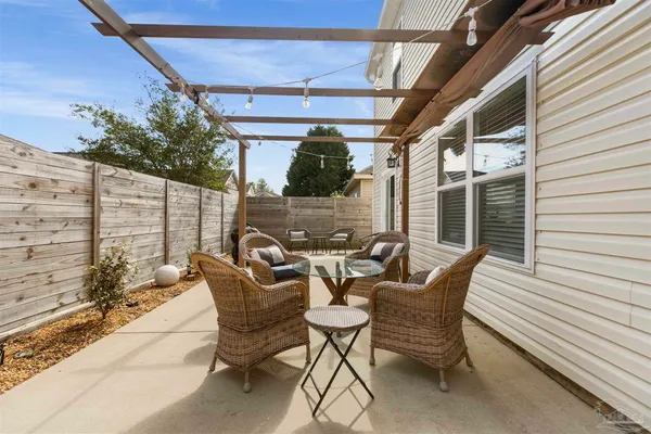 a view of a patio with table and chairs and potted plants