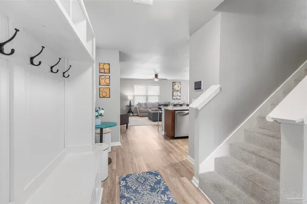 a living room with furniture and stairs