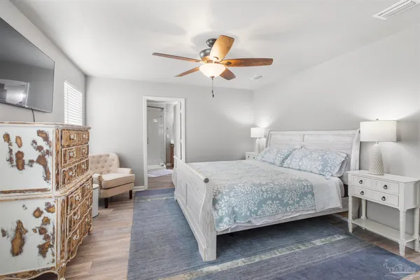 a bedroom with a bed and a chandelier