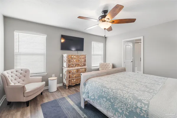 a bedroom with a bed a couch and a window