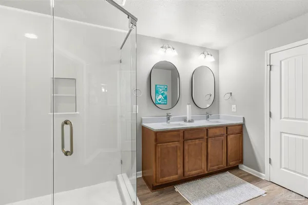 a bathroom with double vanity sink and a mirror