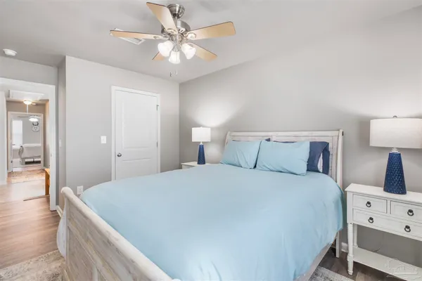 a bedroom with a bed and a chandelier