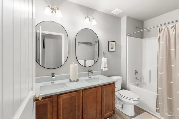 a bathroom with a toilet a sink and a mirror