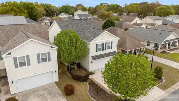 an aerial view of a house with a yard