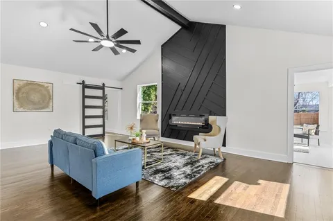 a living room with furniture and a wooden floor