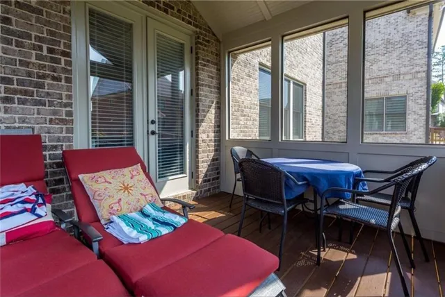 a living room with furniture and floor to ceiling windows