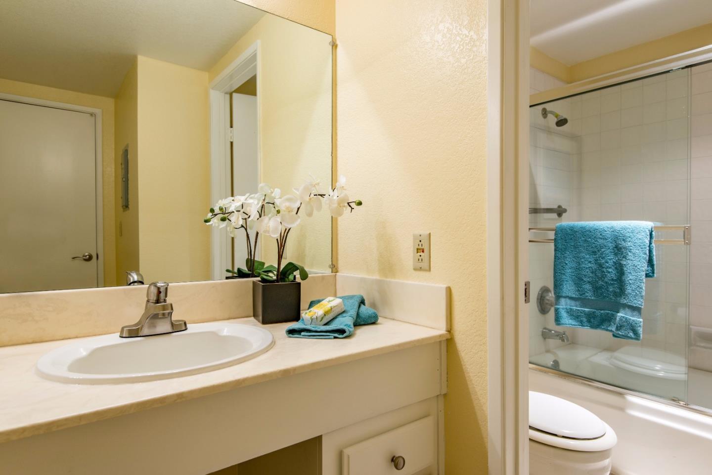 20666 Celeste Circle Cupertino, CA 95014 - Photo 13 of 15 a bathroom with a granite countertop sink a toilet and shower