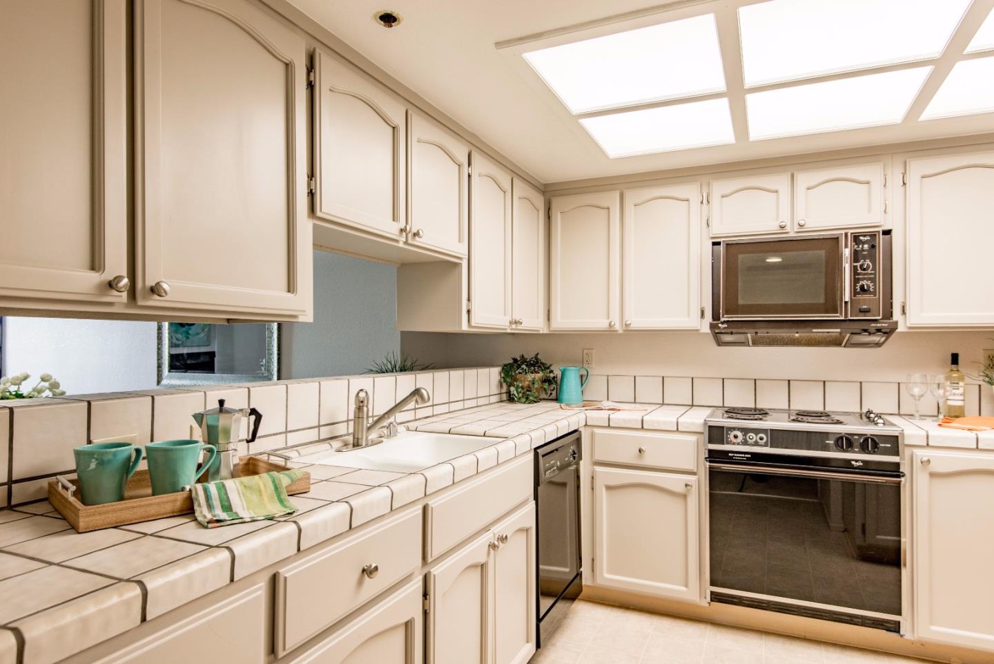 20666 Celeste Circle Cupertino, CA 95014 - Photo 9 of 15 a kitchen with stainless steel appliances granite countertop a stove a sink and a microwave