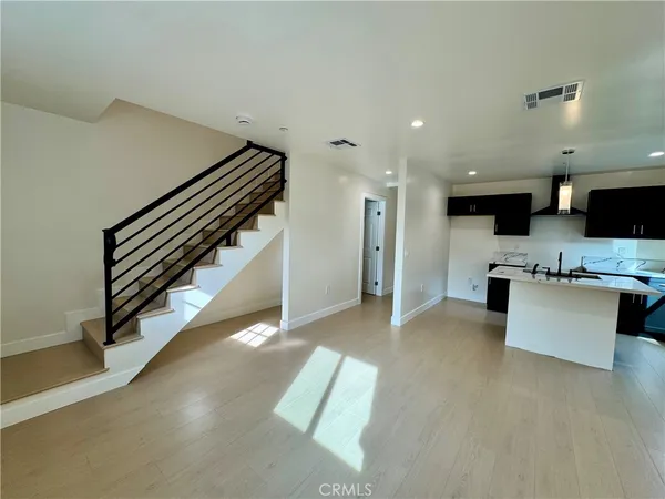 a view of living room with furniture and kitchen view