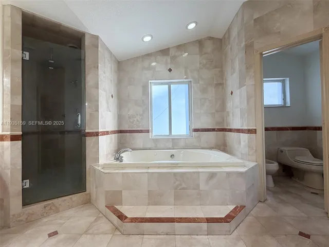 a bath tub sitting next to a white sink