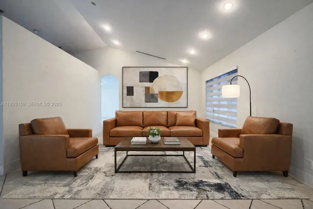 a living room with furniture and a mirror