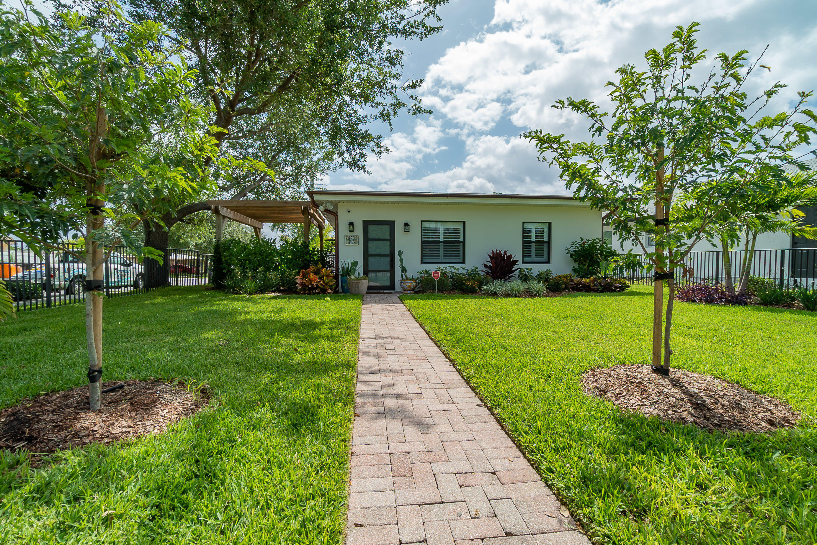 a view of a house with a yard and garden
