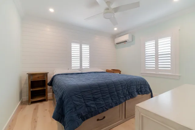 a bedroom with a bed and a computer on the desk