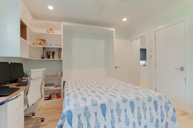 a room with a workspace and a window