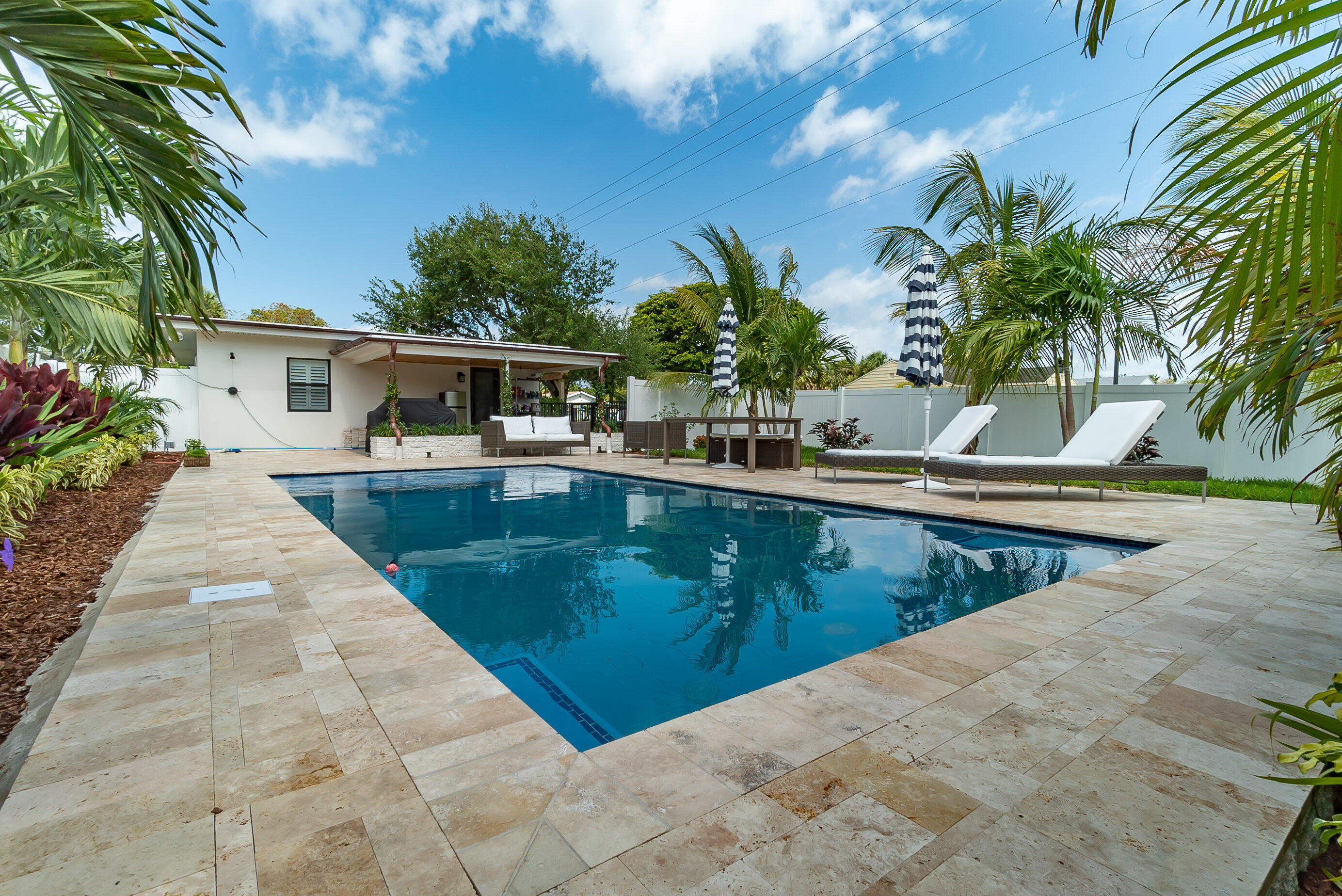 301 South Swinton Avenue Delray Beach, FL 33444 - Photo 25 of 29 a view of a swimming pool with a patio