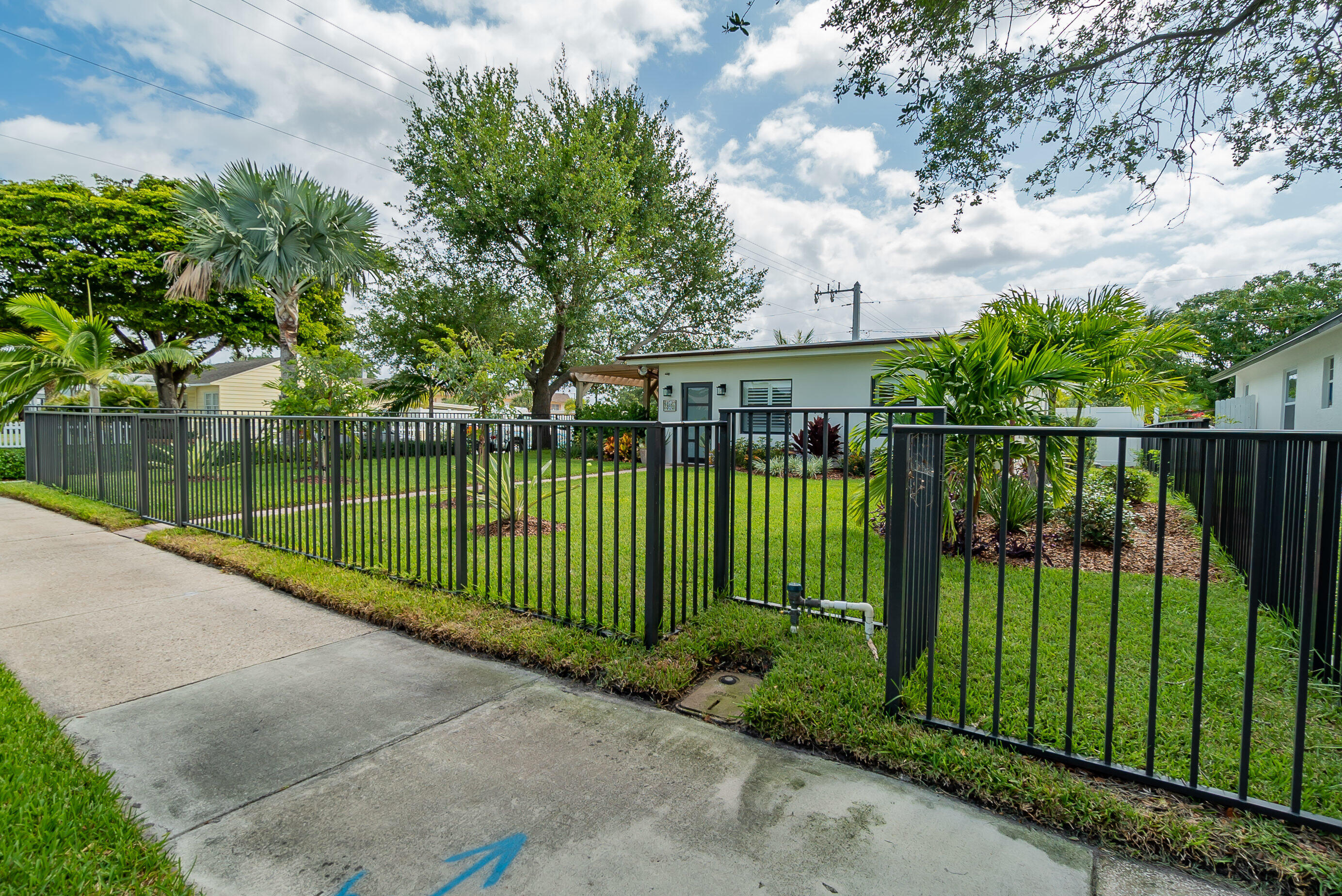 301 South Swinton Avenue Delray Beach, FL 33444 - Photo 3 of 29 a view of a wrought iron fences in front of house