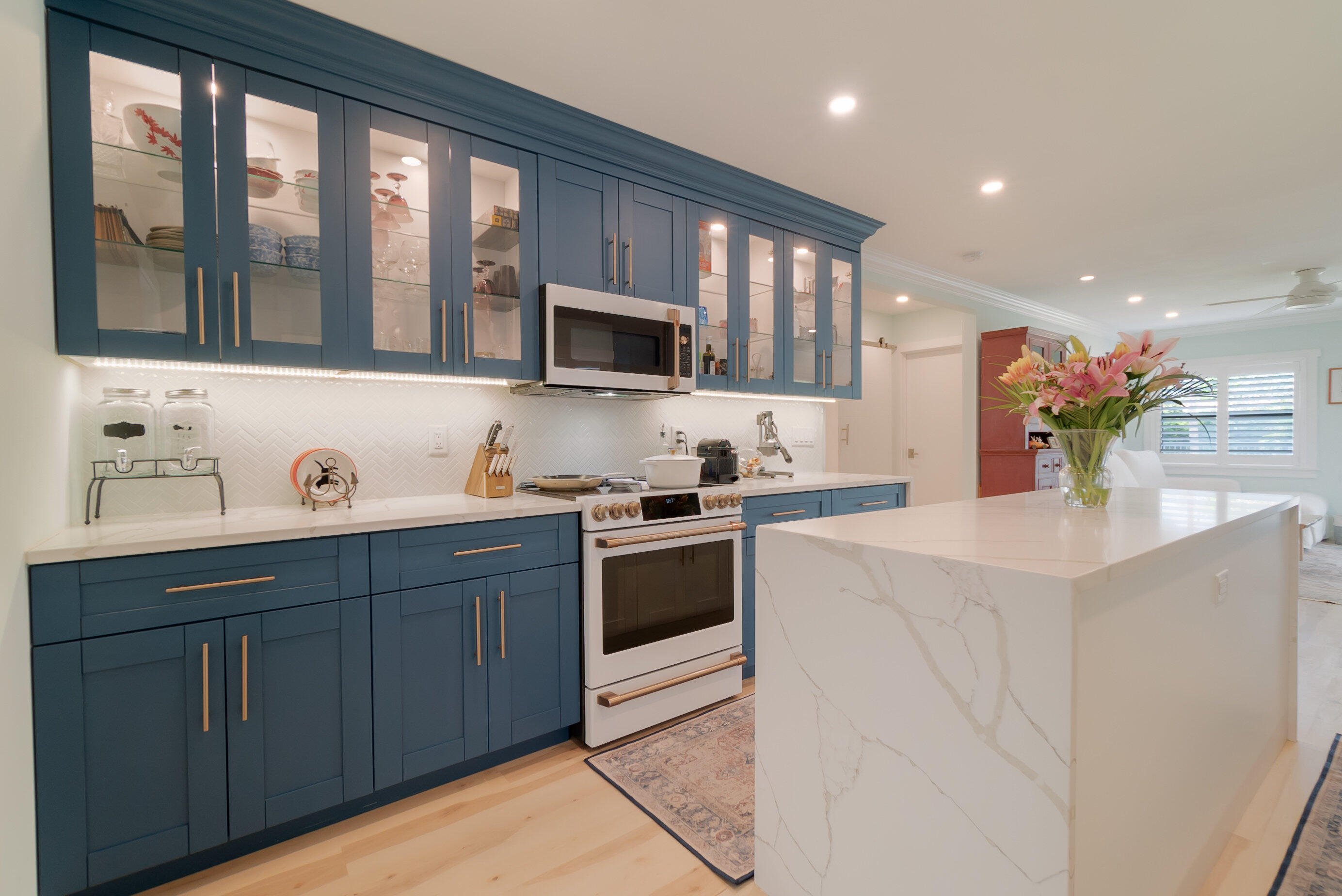 301 South Swinton Avenue Delray Beach, FL 33444 - Photo 7 of 29 a kitchen with a sink and a stove top oven with wooden floor