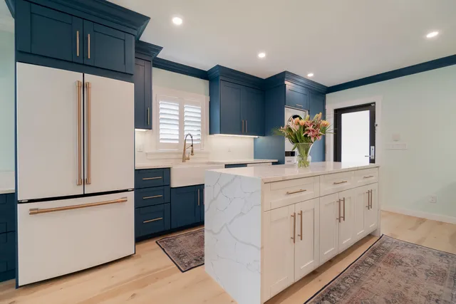 a room with a refrigerator and a workspace