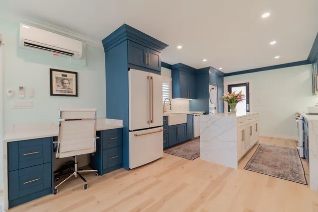 a living room with furniture and kitchen view