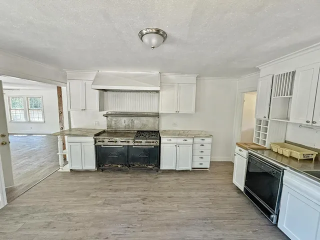 a kitchen with a stove oven and sink