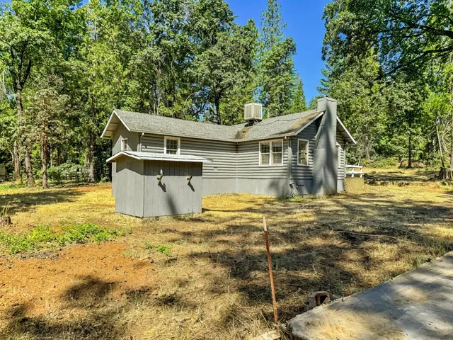 a white house that has a tree in it