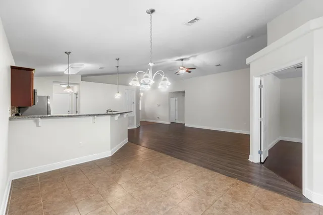 a view of a kitchen with a sink and refrigerator