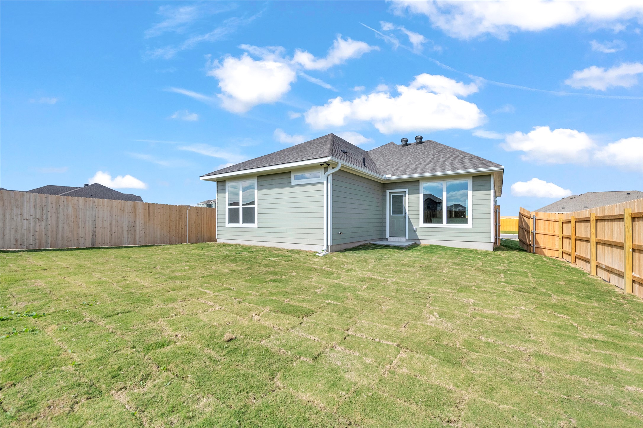 308 Boatright Boulevard Jarrell, TX 76537 - Photo 31 of 31 Back of house with a fenced backyard and a shingled roof