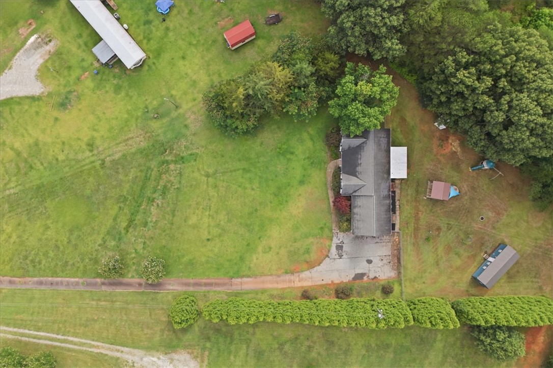 520 Sharon Lane Seneca, SC 29678 - Photo 4 of 48 An aerial perspective reveals a serene, expansive green lot with a private driveway.