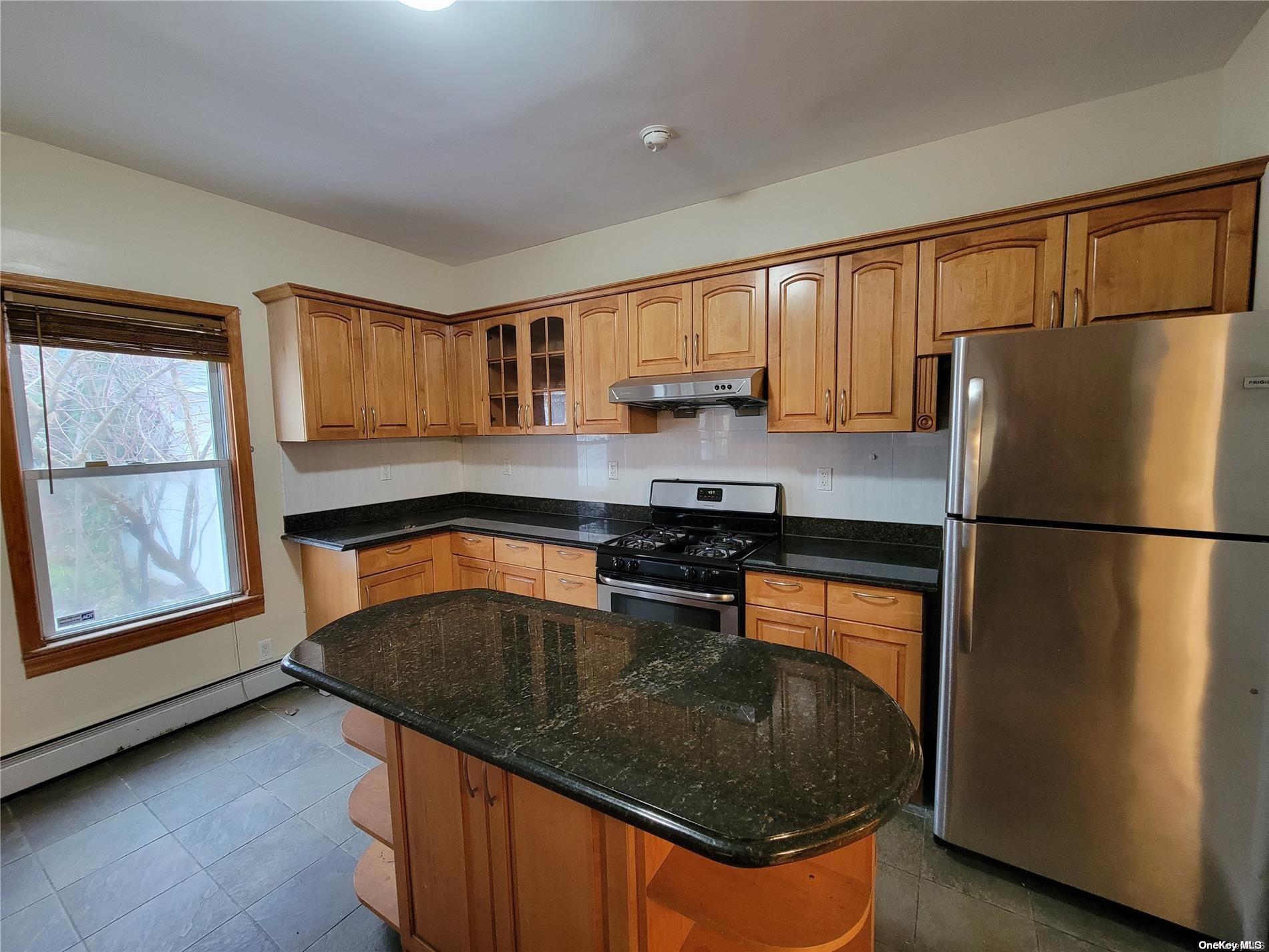 85-30 79th Street Queens, NY 11421 - Photo 15 of 23 a kitchen with granite countertop stainless steel appliances a refrigerator a sink a stove and cabinets