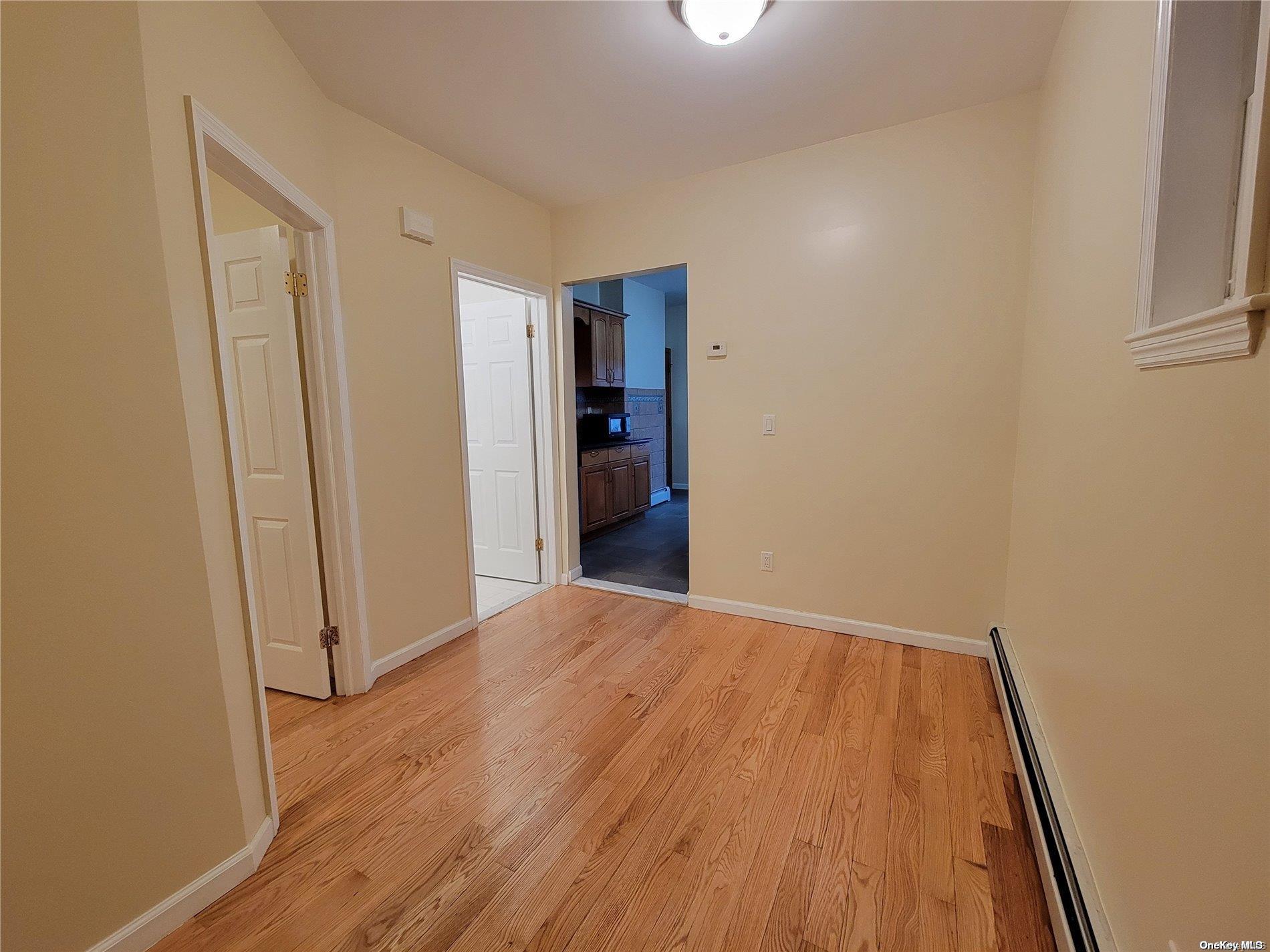 85-30 79th Street Queens, NY 11421 - Photo 17 of 23 wooden floor in an empty room