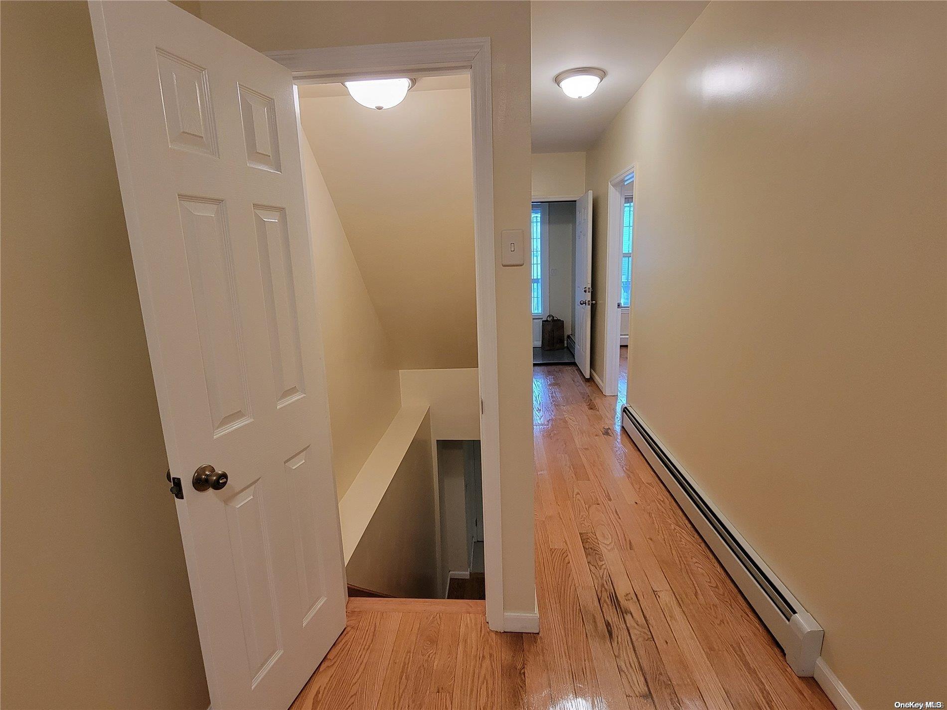 85-30 79th Street Queens, NY 11421 - Photo 18 of 23 a view of a hallway with wooden floor and staircase