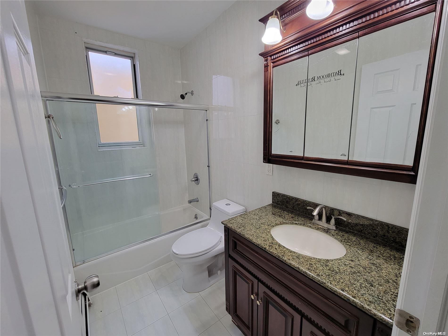 85-30 79th Street Queens, NY 11421 - Photo 10 of 23 a bathroom with a granite countertop sink toilet and shower