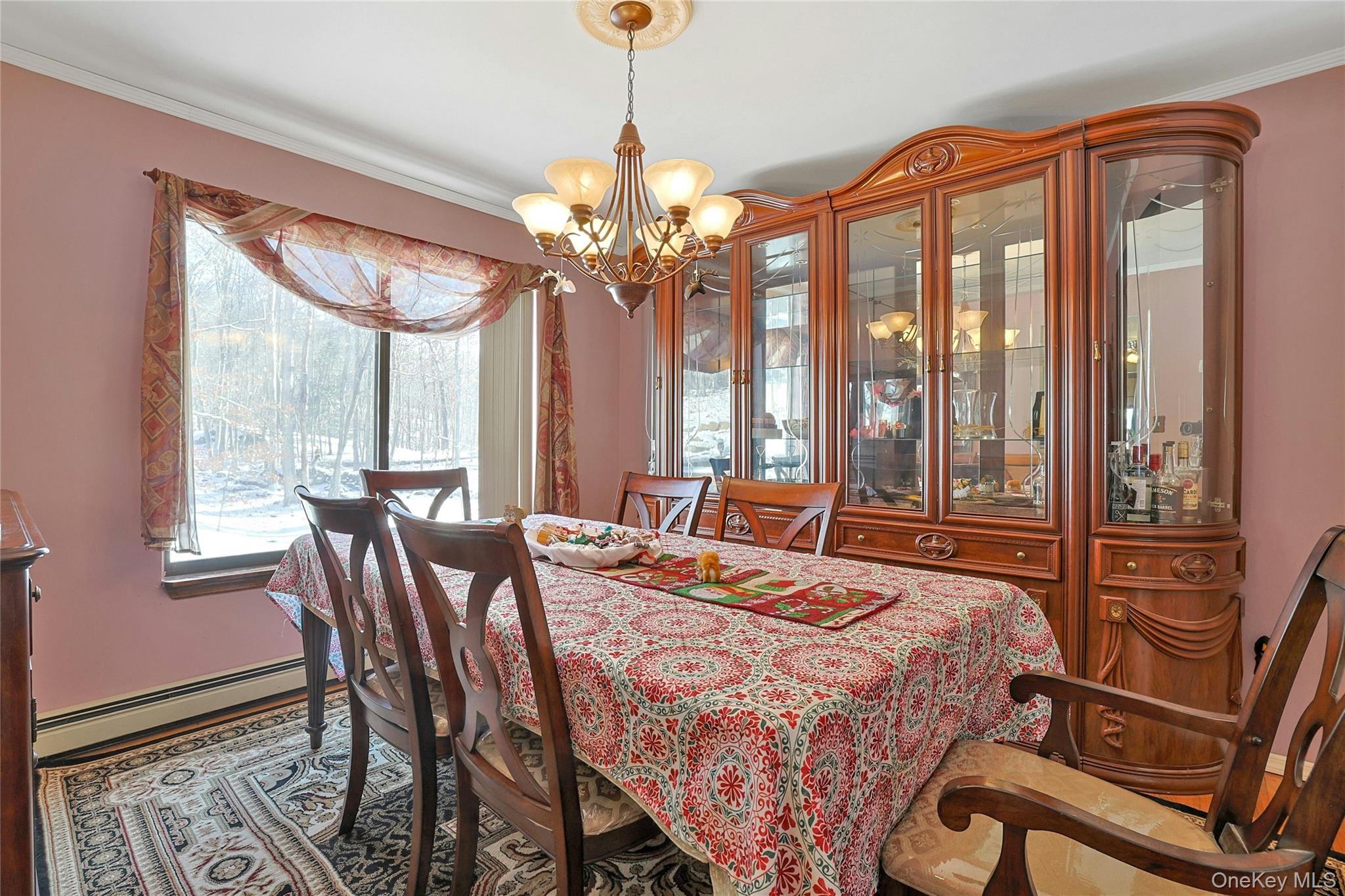 31 Powder Horn Road Cortlandt Manor, NY 10567 - Photo 11 of 36 Dining room featuring a chandelier, ornamental molding, and a baseboard radiator