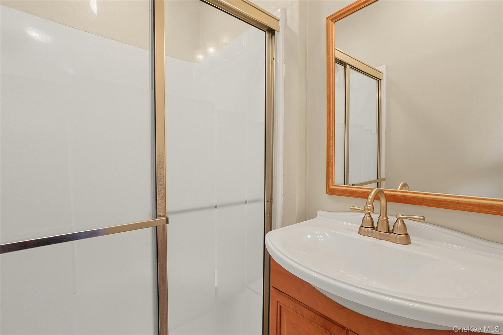 31 Powder Horn Road Cortlandt Manor, NY 10567 - Photo 16 of 38 a bathroom with a sink and a mirror