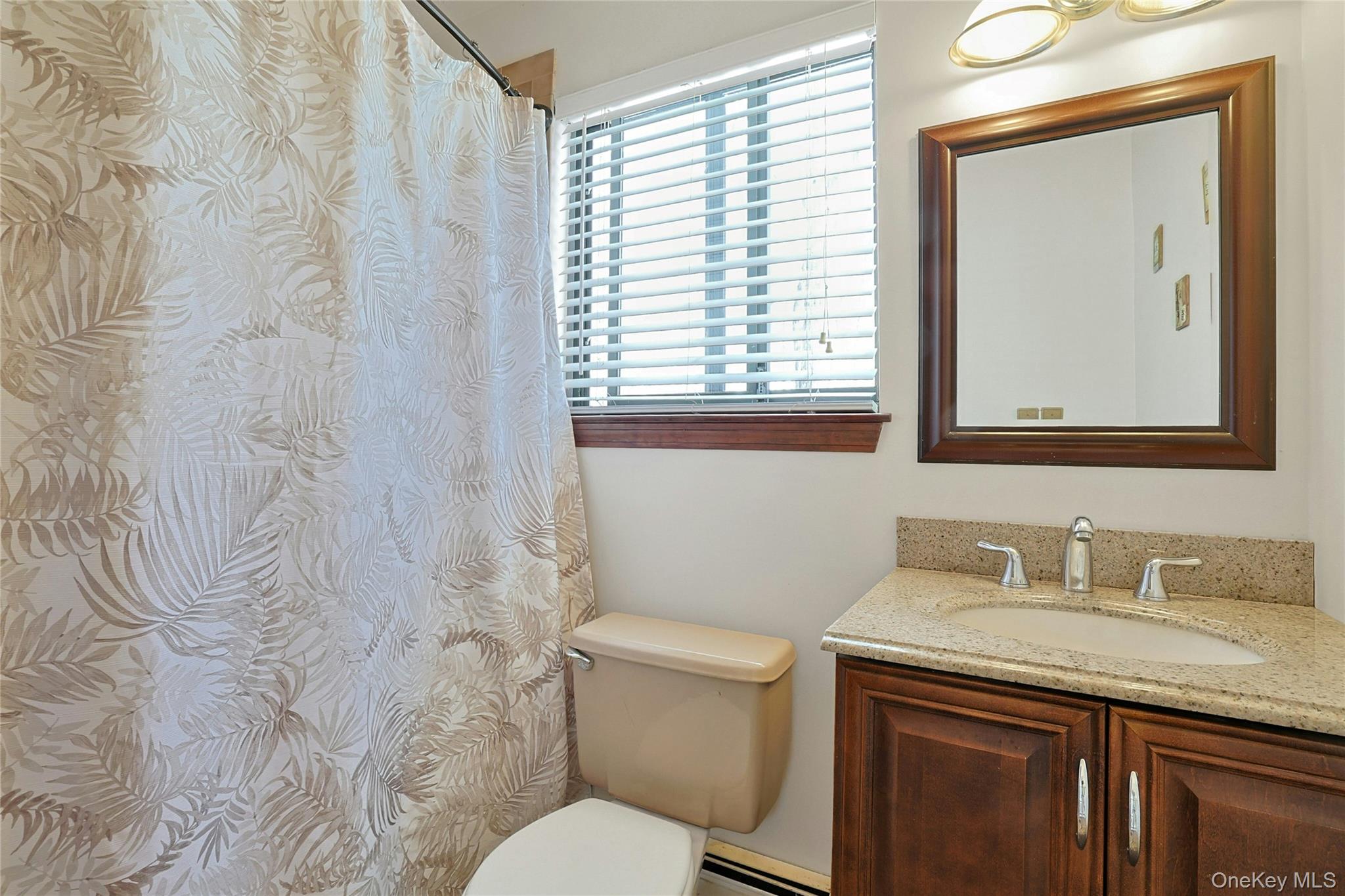 31 Powder Horn Road Cortlandt Manor, NY 10567 - Photo 20 of 38 a bathroom with a granite countertop sink toilet and mirror