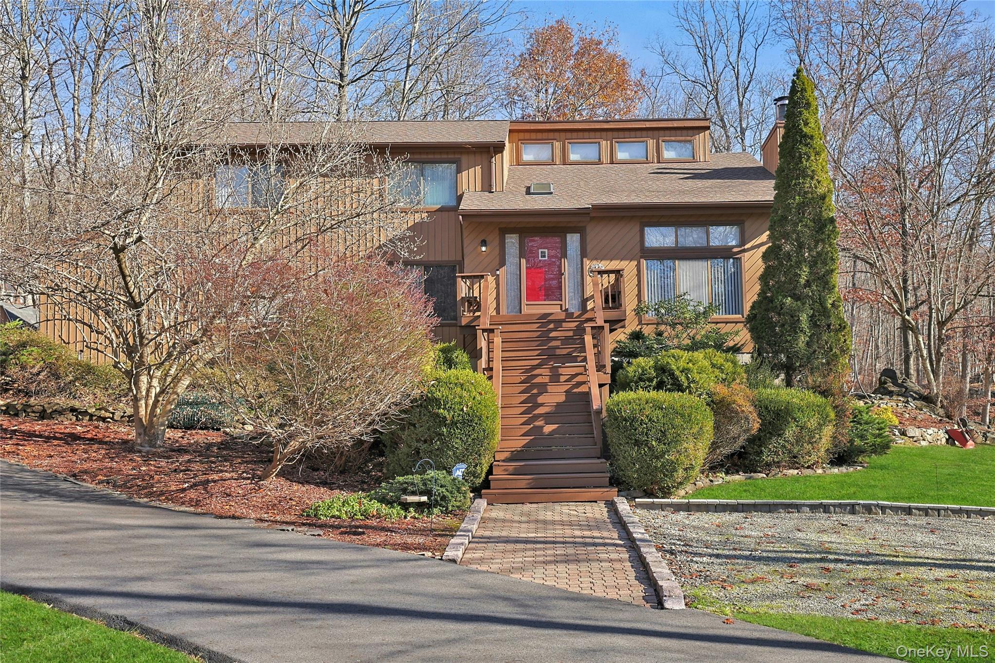 31 Powder Horn Road Cortlandt Manor, NY 10567 - Photo 2 of 38 a front view of a house with garden