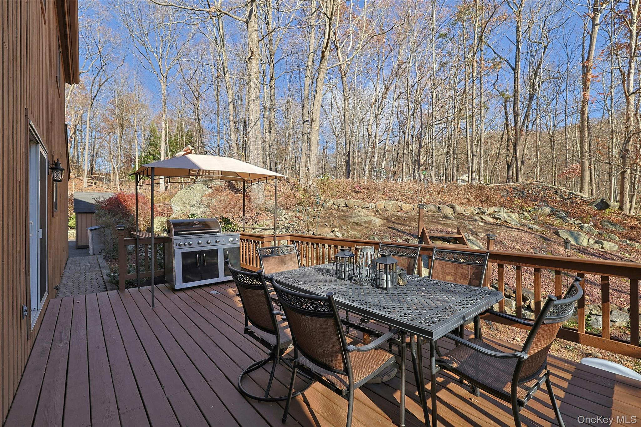31 Powder Horn Road Cortlandt Manor, NY 10567 - Photo 28 of 36 Wooden deck with outdoor dining area and a grill