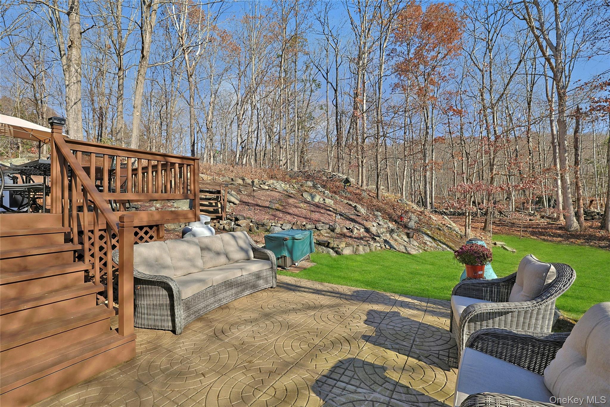 31 Powder Horn Road Cortlandt Manor, NY 10567 - Photo 33 of 38 a view of a chairs and table in the back yard of the house