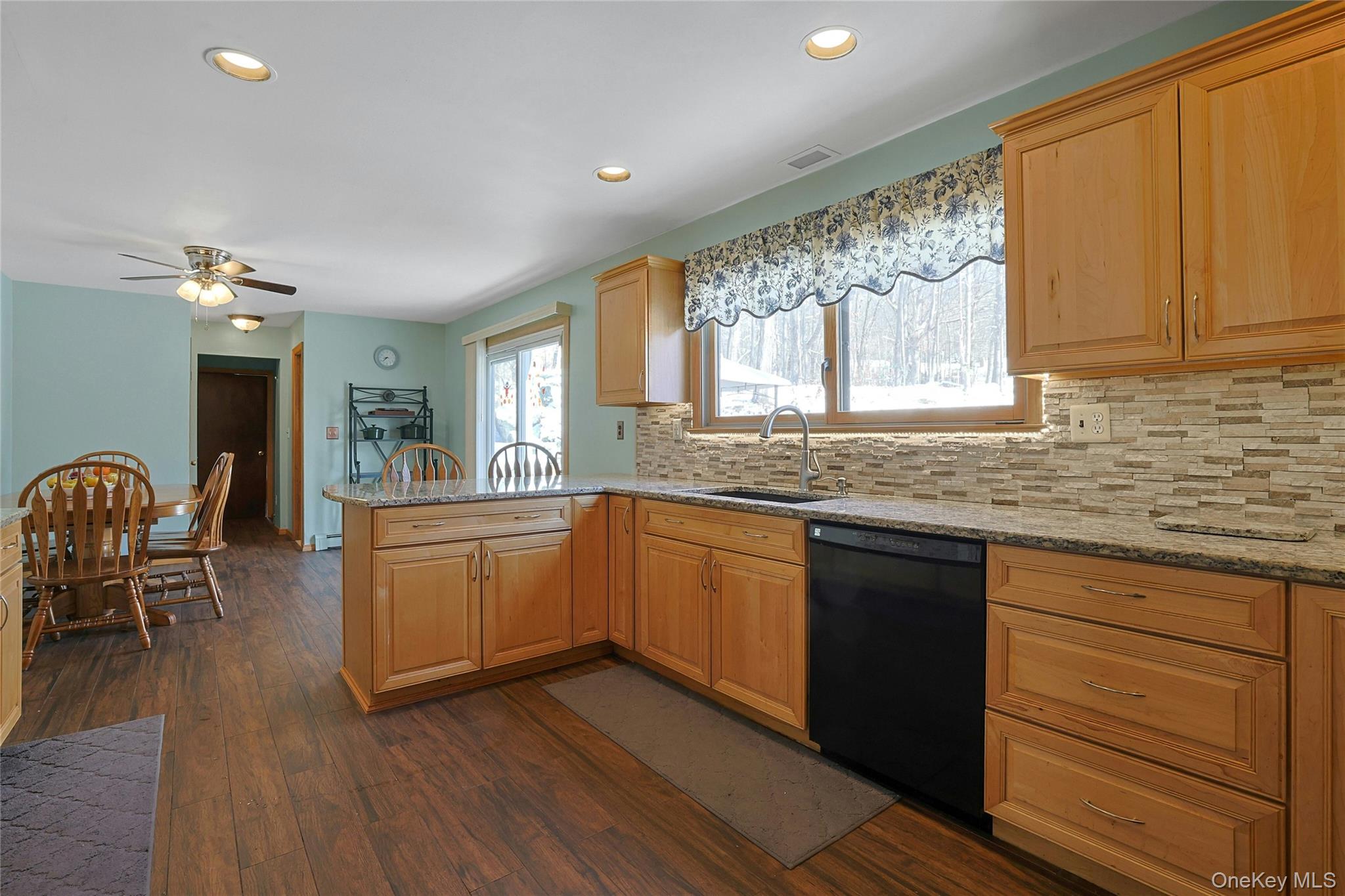 31 Powder Horn Road Cortlandt Manor, NY 10567 - Photo 5 of 38 a kitchen with stainless steel appliances granite countertop wooden floors and granite counter tops