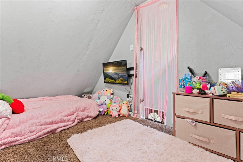 1286 Lovers Lane Rimforest, CA 92378 - Photo 14 of 27 a bedroom with a bed and a flat screen tv