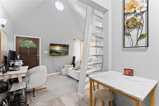 a view of a wooden bench and trees in the background
