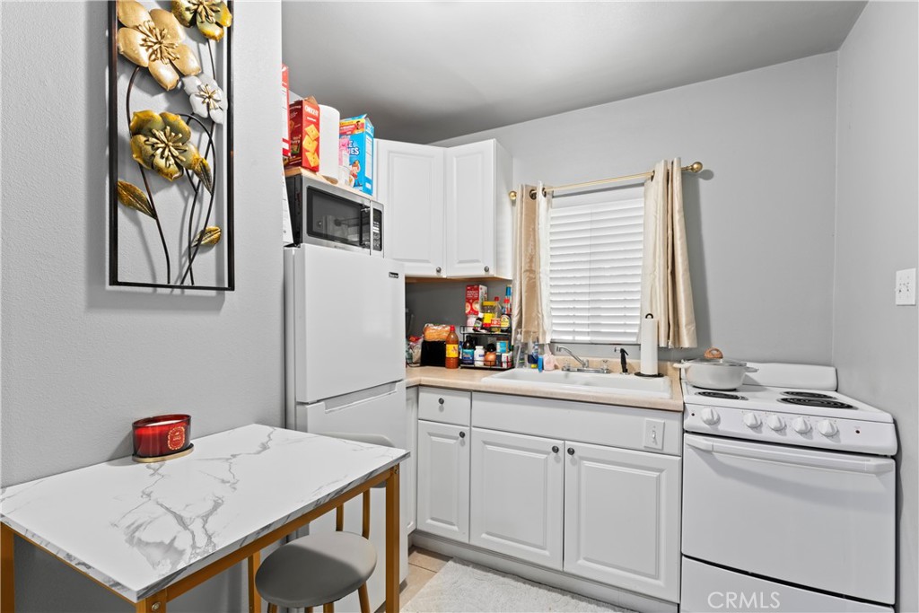 1286 Lovers Lane Rimforest, CA 92378 - Photo 22 of 27 a kitchen that has a cabinets and a stove in it