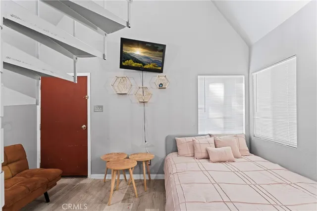 a bedroom with furniture and wooden floor