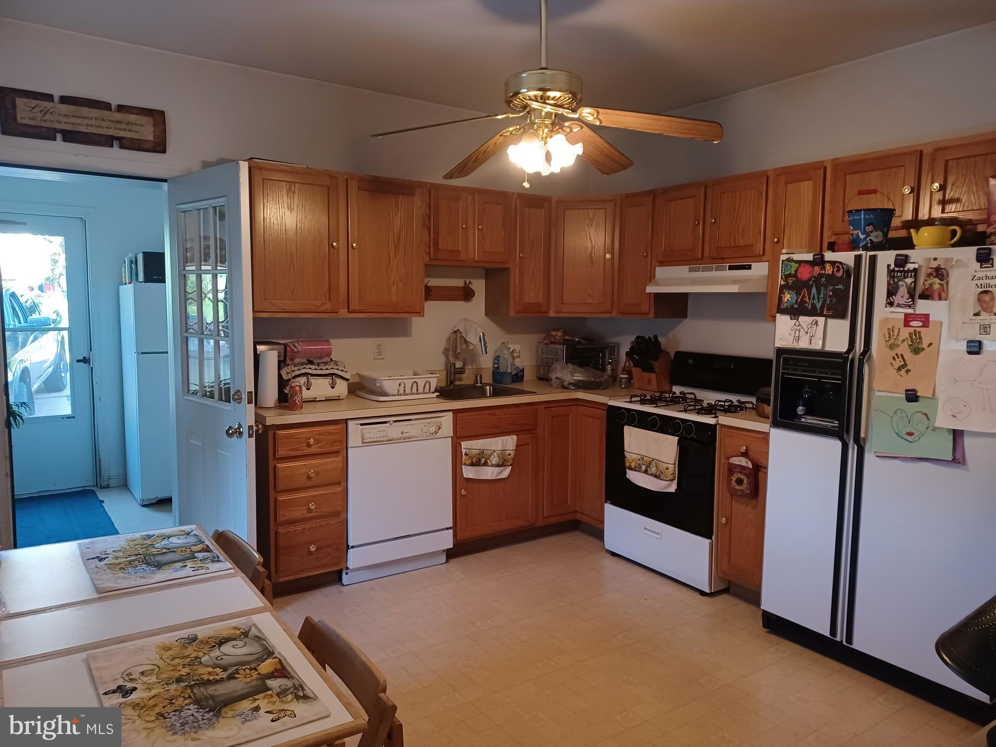 2409 Hammonds Ferry Road Halethorpe, MD 21227 - Photo 3 of 10 a kitchen with stainless steel appliances kitchen island granite countertop a stove refrigerator and cabinets