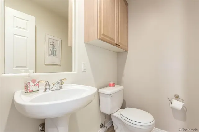 a bathroom with a sink a mirror and a toilet