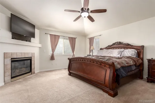 a spacious bedroom with a bed and a flat screen tv
