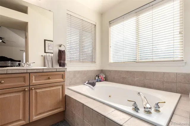 a bathroom with a tub sink and a window