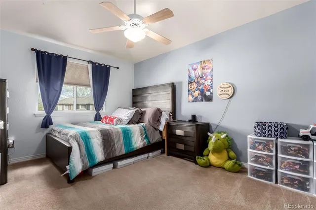 a spacious bedroom with a bed and a chandelier