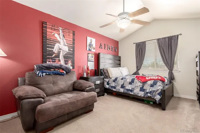 a bedroom with furniture and a large window